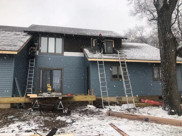 Roach roofing crew working on a home during winter